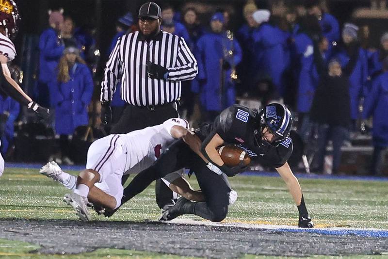 Lincoln-Way East’s MJ Schley makes a catch for the first down against Loyola in the Class 8A semifinal on Saturday, Nov. 23, 2024 in Frankfort.