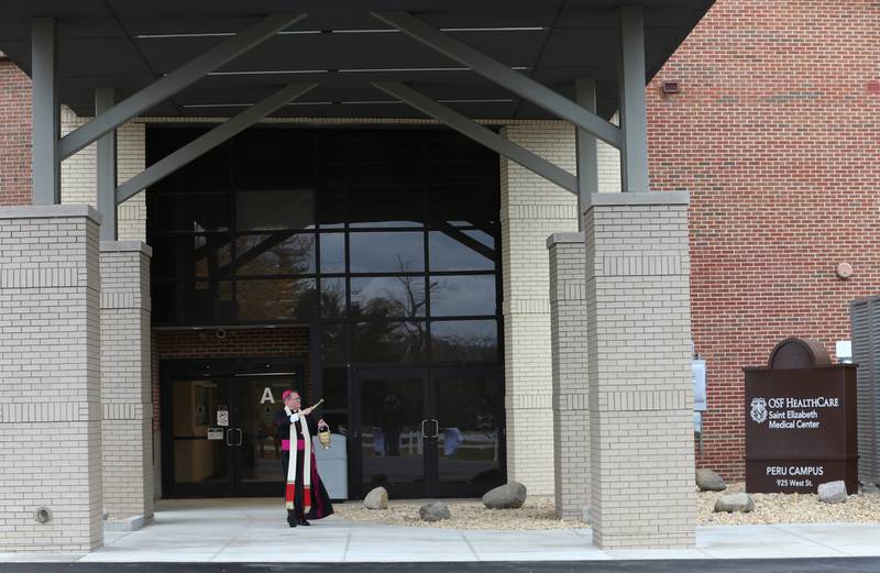 Bishop Louis Tylka of the Catholic Diocese of Peoria blesses the main entrance on Thursday, Oct. 31, 2024 at OSF HealthCare Saint Elizabeth Medical Center in Peru.
