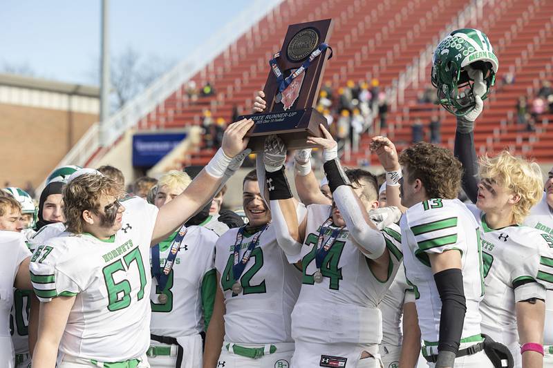 Brown County hoists the second place trophy after falling to Lena-Winslow 58-13 Friday, Nov. 28, 2025, in the Class 1A football finals at Hancock Stadium at ISU.