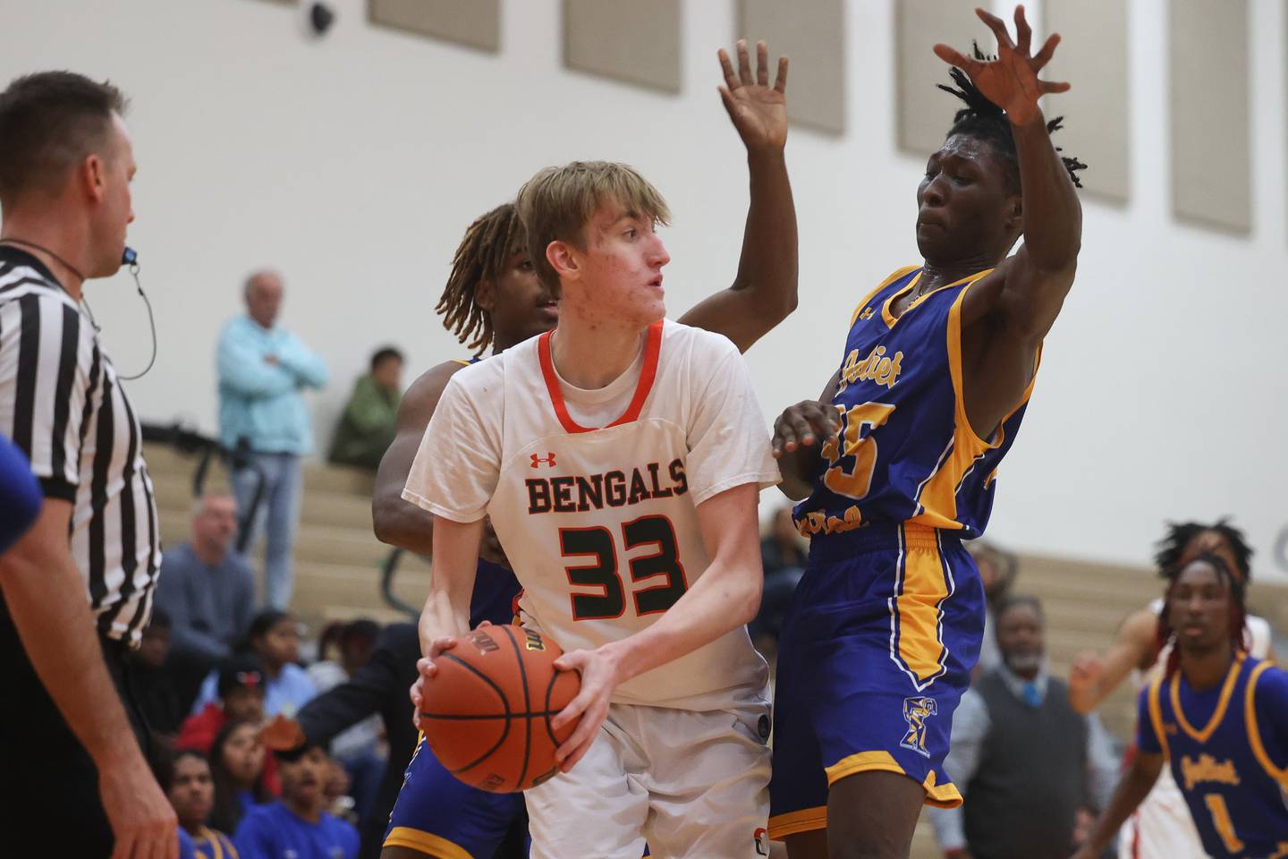 Plainfield East’s Andrew Soenksen looks to pass under pressure by Joliet Central.
