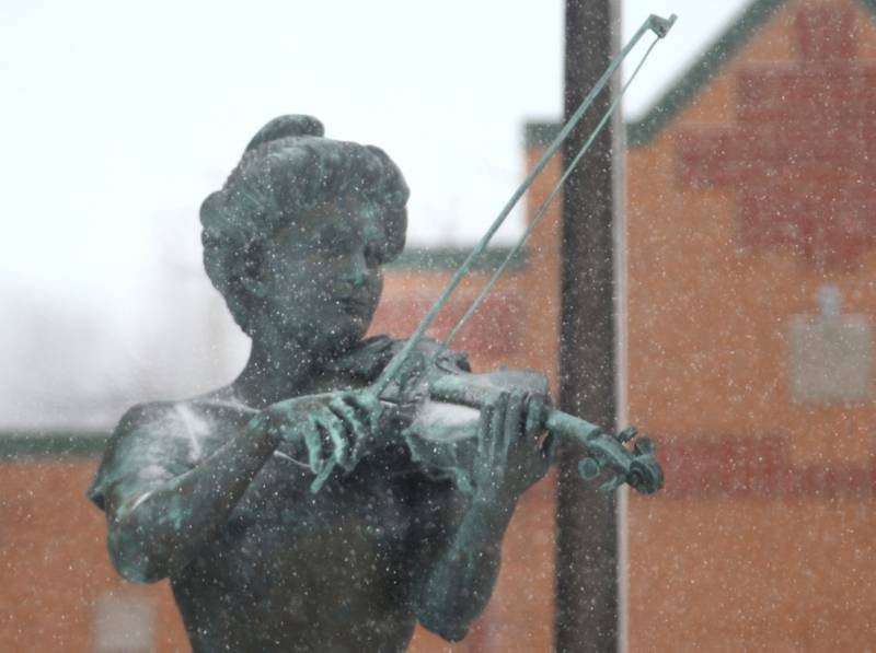 Snow begins to stick on the Maud Powell Statue on Wednesday, Feb. 12, 2025 downtown Peru.
