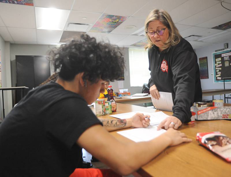 Teacher Anne Whitney-Turbidy answers student Marcos Ortiz’s question as she teaches about food labels during a health class Tuesday, April 19, 2022, at Haber Oaks Campus in Crystal Lake.