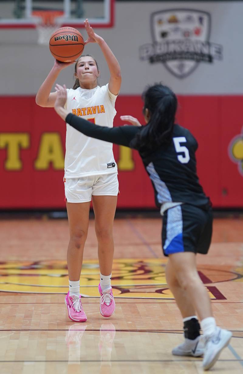 Batavia's Addi Lowe (4) shoots a three pointer against St. Charles North's Sydney Johnson (5) during a basketball game at Batavia High School on Tuesday, Dec 5, 2023.