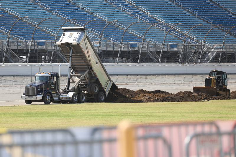 A truck dumps dirt on Tuesday as a bulldozer works on the motocross course at the Chicagoland Speedway as crew setup for Saturday’s SuperMotocross World Championship Finals in Joliet.