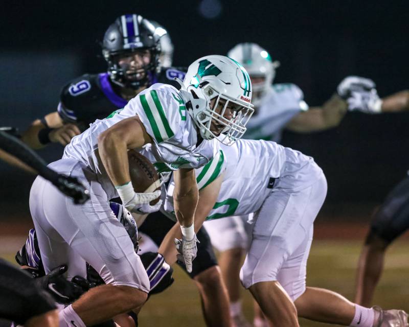 York's Jake Mellon (30) avoids the defense during football game between York at Downers Grove North.  Sept 29, 2023