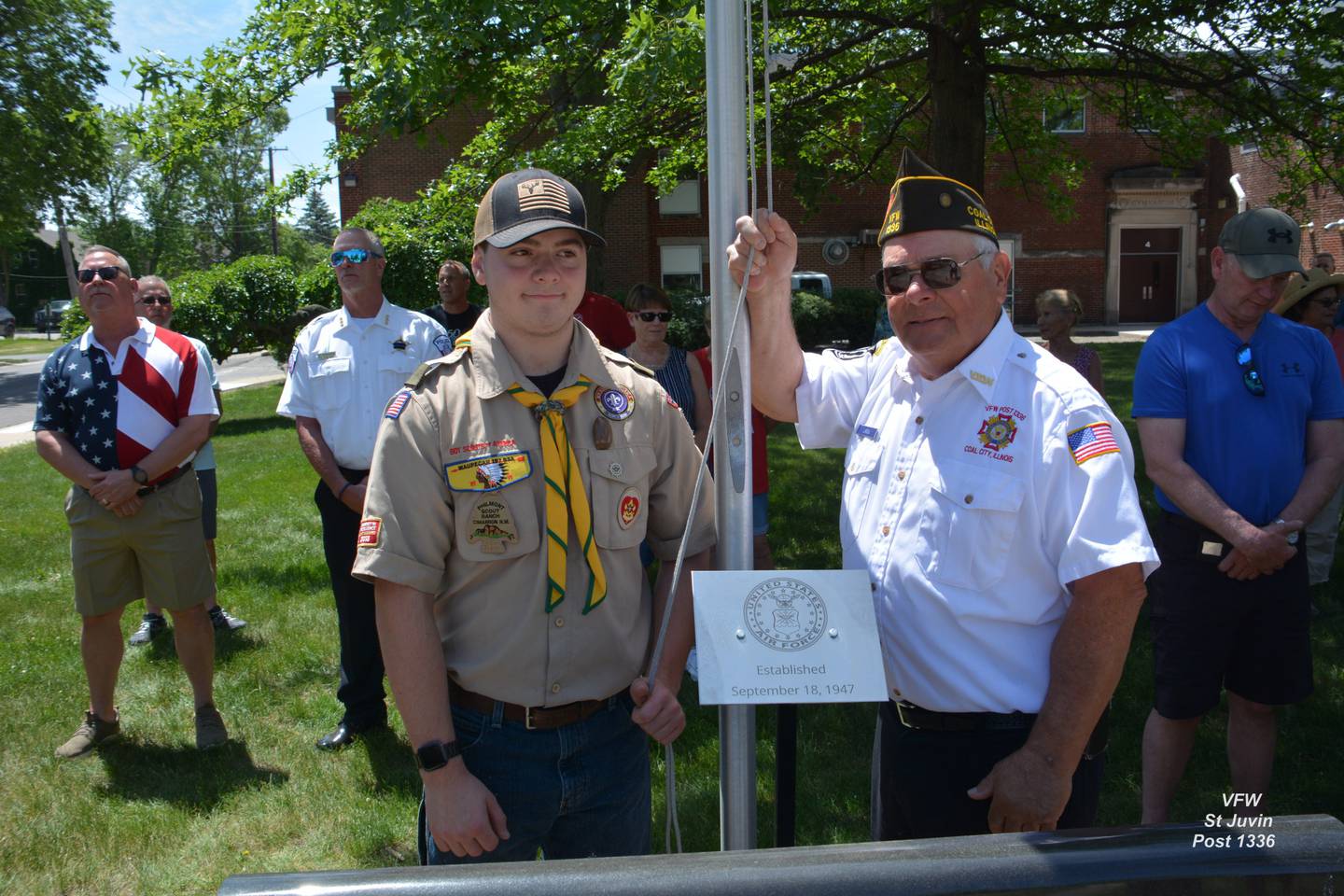 St. Juvin Post Life Member and Air Force Vet Mike Lareau (right) and grandson Life Scout Ethan Bach prepare to raise the Air Force service flag to full staff.