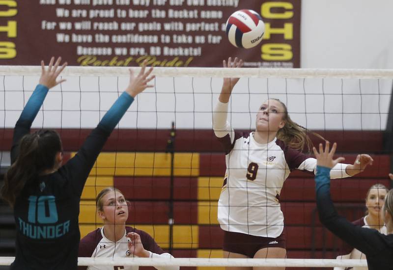 Richmond-Burton's Reagan Wisniewski (right) hit the ball over Richmond-Burton's Daniella Mazzola (left) during a Kishwaukee River Conference volleyball match on Wednesday, Oct. 15, 2025, at the Richmond-Burton High School in Richmond.