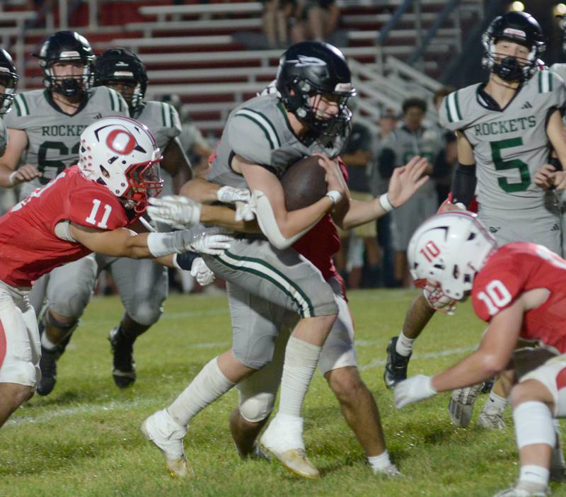 Rock Falls' Phillip Grffiith, Jr. runs for a gain as Oregon;'s Keaton Salsbury (10) and Jayden Berry (11) defend on Friday, Sept. 19, 2025 at Landers-Loomis Field in Oregon.