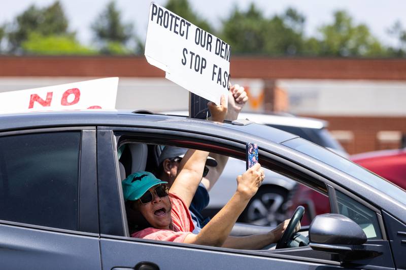 A protestor driving on Randall Road screams to other protesters lined up along South Randall Road during a “No Kings Day” Protest against President Donald Trump’s policies in Geneva on Saturday, June 14, 2025.