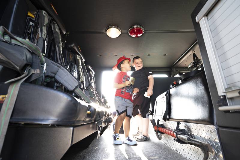 Ackstyn (left), 3, and James Bradley, 6, check out the inside of the Dixon Fire tower truck Tuesday, August 5, 2025, that was put on display at the National Night Out celebration.