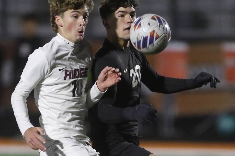 Prairie Ridge's Chase Santucci battles McHenry's Aiden Fischler for control of the ball during a Fox Valley Conference soccer match on Tuesday, Oct. 15, 2024, at McCraken Field in McHenry.
