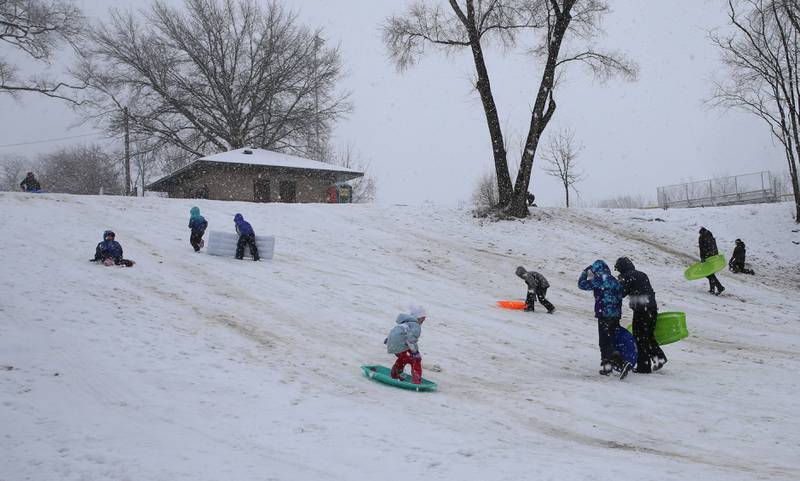 Kids snowboard and sled at McKinley Park on Tuesday, Jan. 9, 2024 in Peru.