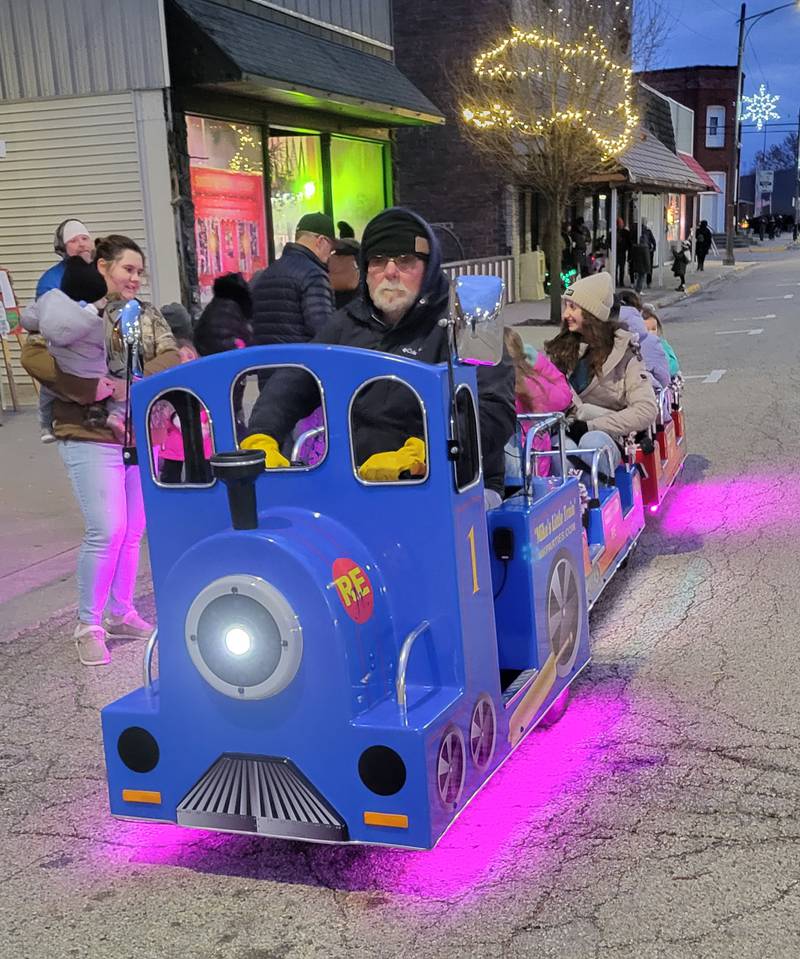 Dozens of children attending the Ladd Christmas Parade festivities enjoyed rides on "Mike's Little Train" running up and down North Main Street on Saturday.