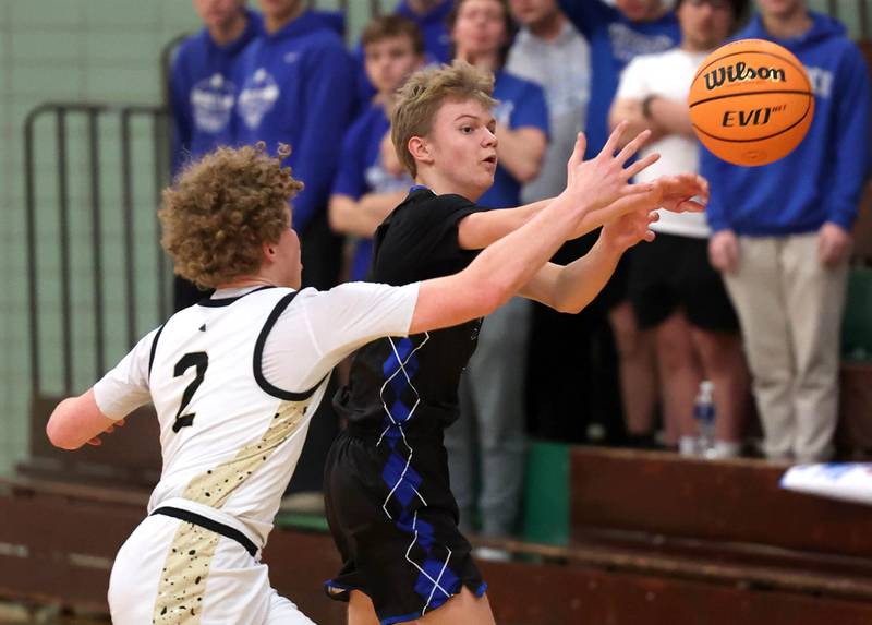 Woodstock's Rian Hahn-Clifton passes the ball away from the pressure of Sycamore's Logan Hodges Friday, Feb. 27, 2026, during their IHSA Class 3A boys basketball regional championship game at Boylan Catholic High School in Rockford.