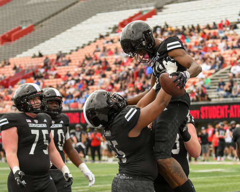 Northern Illinois University's Abiathar Curry, left, lifts up teammate Andrew McElroy after Andrew scored a touchdown during a scrimmage on Saturday April 27, 2024, held at Huskie Stadium in DeKalb.