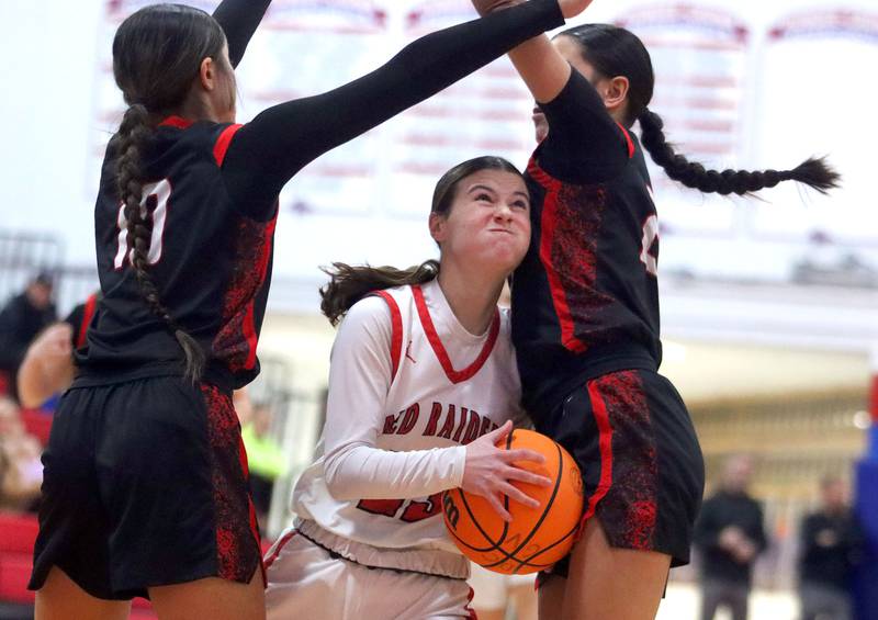 Huntley’s Aubrina Adamik splits the Mundelein defense in varsity girls basketball Komaromy Classic tournament  action on Tuesday, Dec. 30, 2025, at Dundee-Crown High School in Carpentersville.