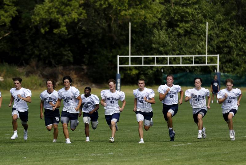 Cary-Grove players runs the field during their first football practice of the upcoming season on Monday, August 11, 2025, at Cary-Grove High School.
