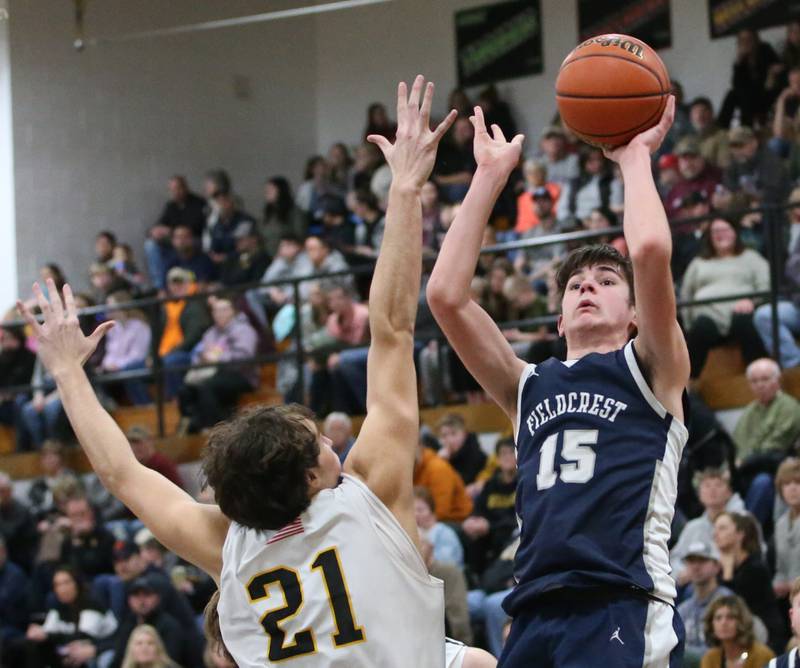 Fieldcrest's Brady Ruestman shoots a shot over Putnam County's Orlando Harris on Tuesday, Feb. 7, 2023 at Putnam County High School.