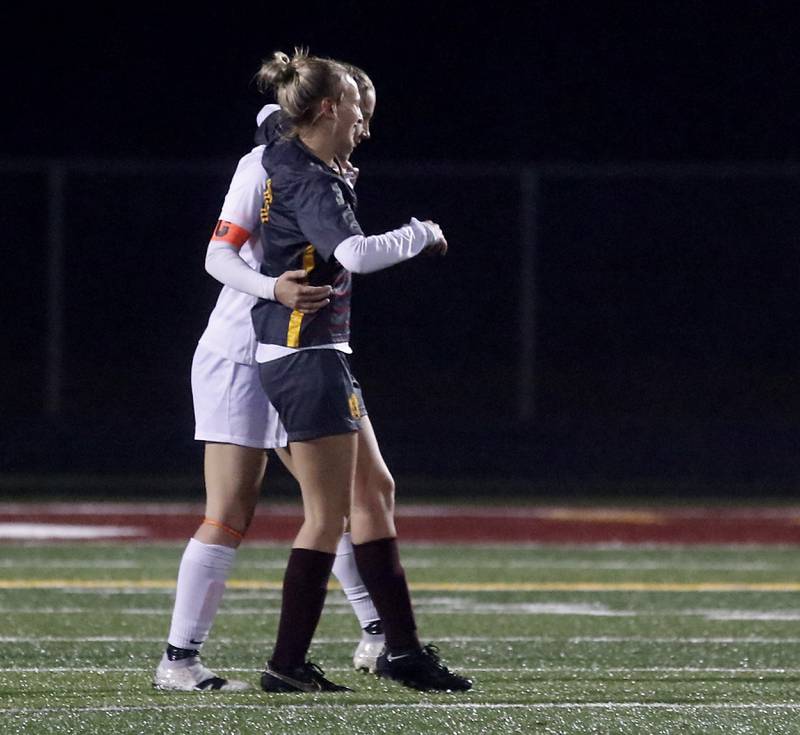 McHenry's Emerson Gasman helps Richmond-Burton's Layne Frericks off the field after an injury during a non-conference girls soccer match Thursday, March 16, 2023, at Richmond-Burton High. McHenry defeated Richmond Burton 4-0, in the first game of the season for both teams.