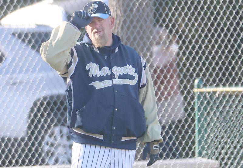 Marquette head baseball coach Todd Hopkins tips his cap while coaching his team against Newark on Monday, March 23, 2026 at Newark High School.