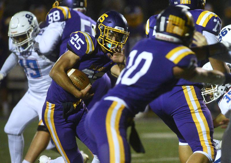 Wauconda's Connor Vanselow (25) looks for running room against the Lakes's defense during Friday’s football game in Wauconda.