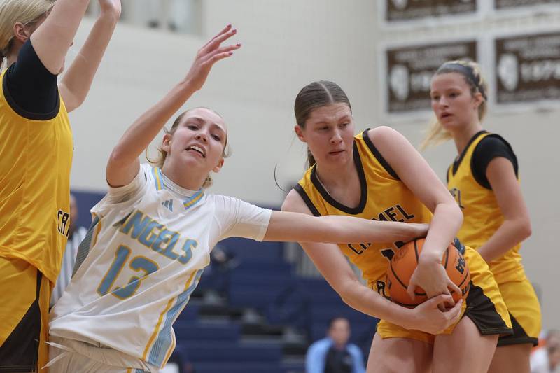 Carmel’s Grace Booher steals the ball away from Joliet Catholic’s Abigail Dulinsky on Wednesday, Jan 15, 2025 in Joliet.