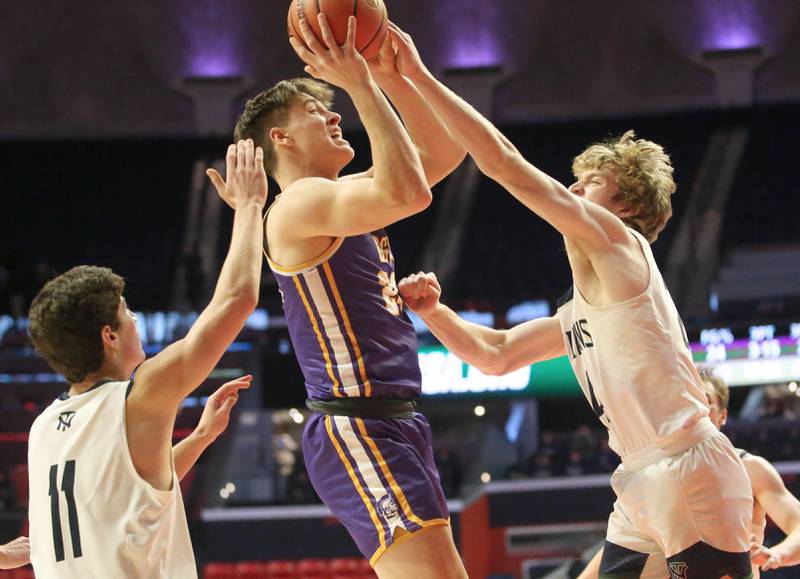 Downers Grove North's George Wolkow looks to shoot a jump shot as North Trier defenders Evan Kanellos and Ian Brown defend in the Class 4A state third place game on Friday, March 10, 2023 at the State Farm Center in Champaign.