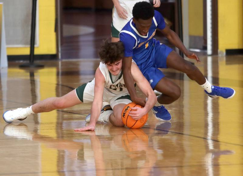Johnsburg’s Jarrel Albea tussles with Boylan’s Alex Ambrose, left, in varsity boys basketball Hinkle Holiday Classic action on Tuesday, Dec. 23, 2025, at Jacobs High School in Algonquin.