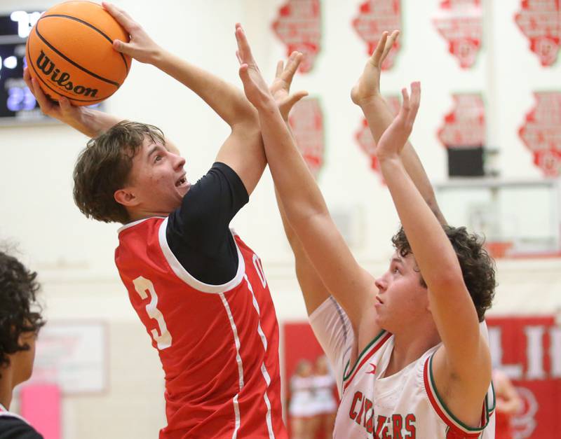 Ottawa's Connor Diederich eyes the hoop as L-P's Mikey Hartman defends on Friday, Feb. 7, 2025 in Sellett Gymnasium at L-P High School.