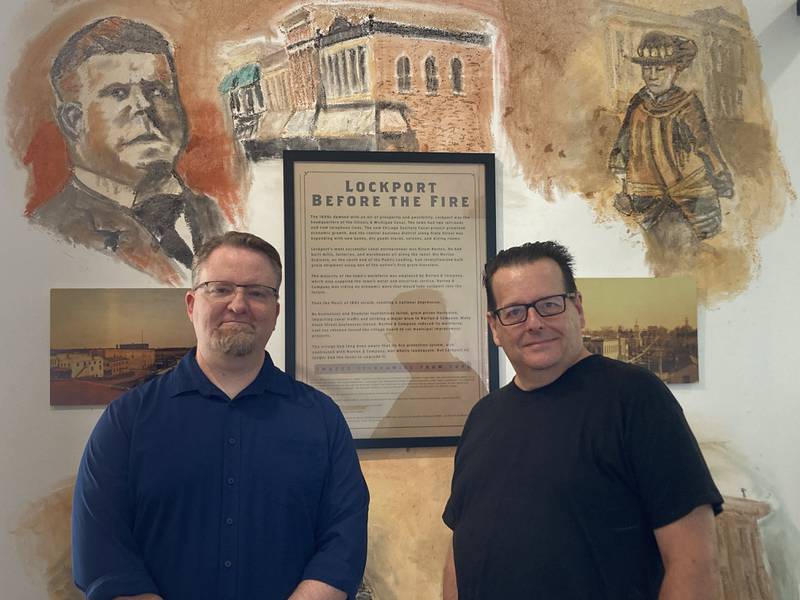 Artist Kevin Traynor and Gaylord Building Manager of Public Programs Clint Cargile pose in front of mural of former Lockport Mayor Leon McDonald, who owned the building where the fire started.