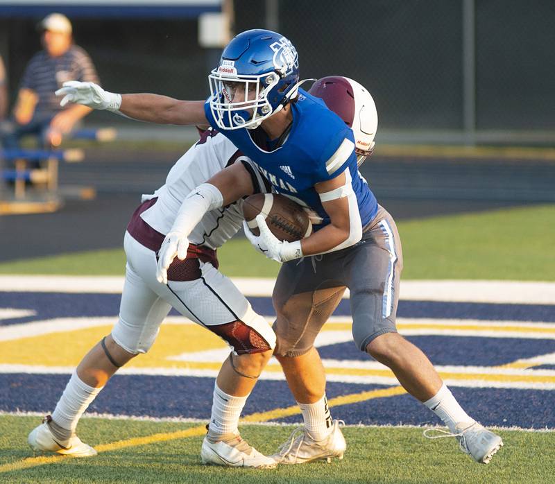 Newman’s Ayden Batten runs back a ball after making an interception early in the game against Rockridge Friday, Sept. 2, 2022.