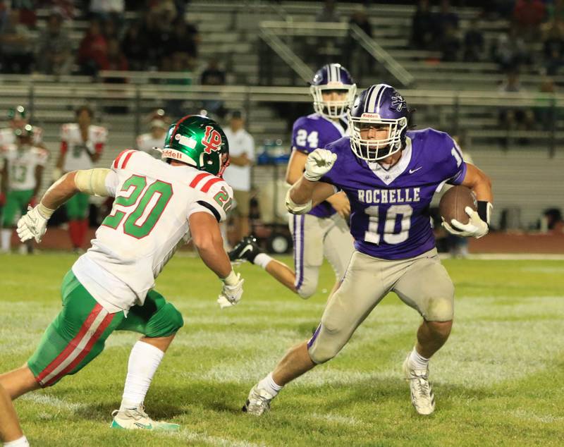 Rochelle's Dylan Manning (10) eludes a tackle of a La Salle-Peru' defender during Friday's game in Rochelle.