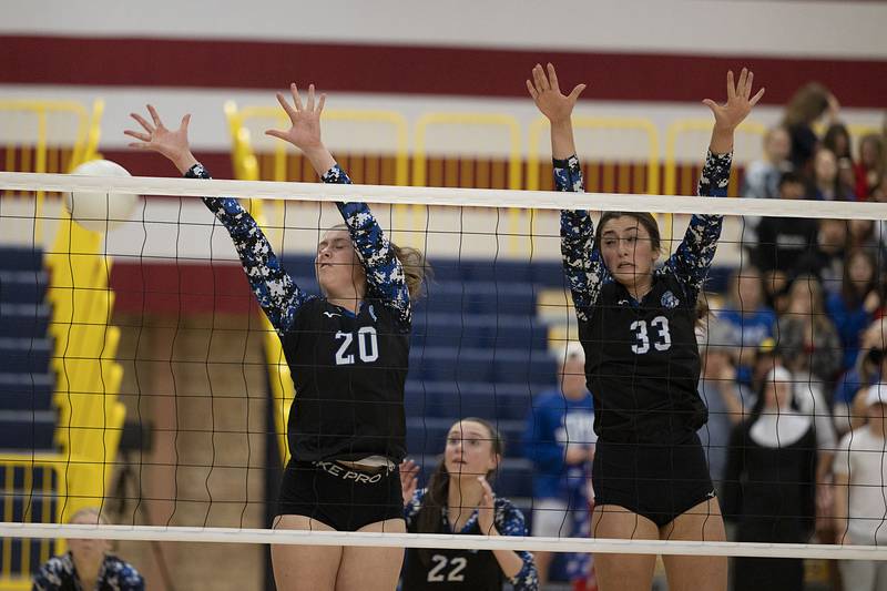 St. Francis’ CeCe Gilroy (left) and Emma Delaney work the net Friday, Nov. 4, 2022 during the Spartan’s 3A supersectional game against Metamora.