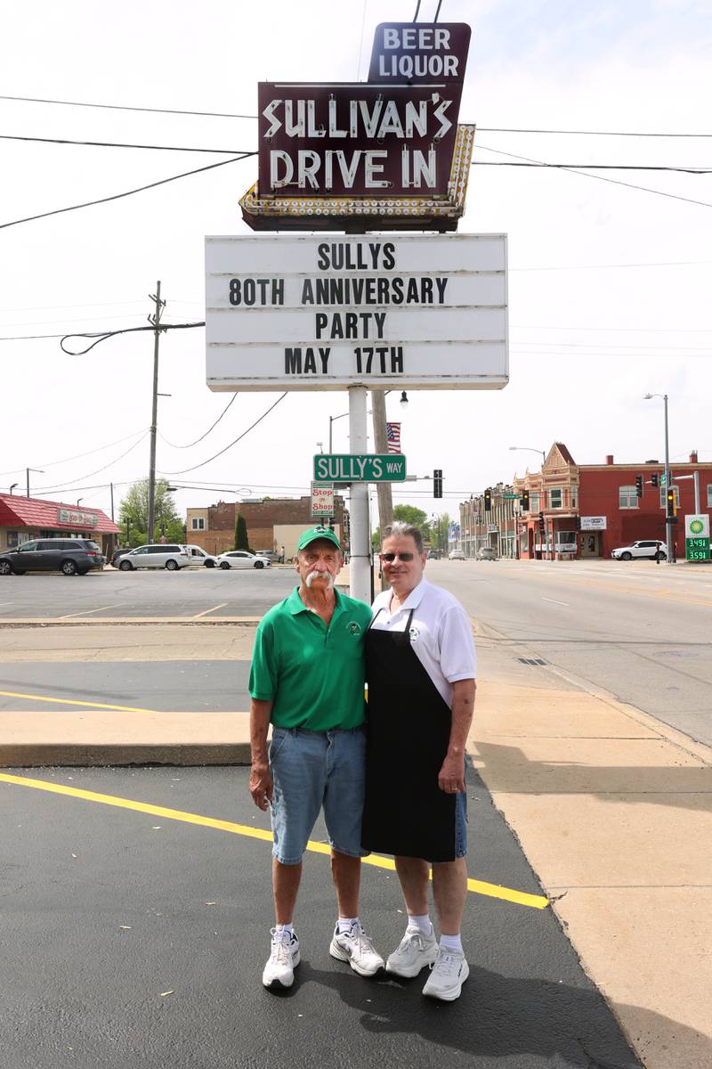 Greg (left) and Earl Sullivan, who own Sullivan's Tavern with brother Albert and sister-in-law Cindy, (not pictured) stand in front of the sign Thursday, May 15, 2025, at the tavern in DeKalb. The bar is celebrating 80 years in business with an event Saturday, May 17, that will include food and live entertainment.