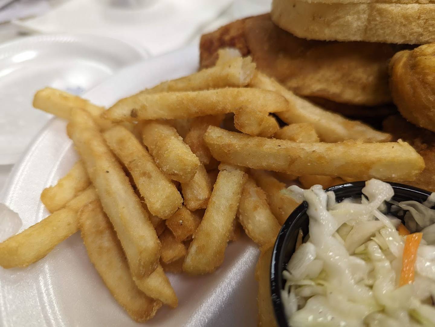 Pictured are the battered fries as part of a half chicken dinner as served at the Knights of Columbus Holy Trinity Council No. 4400 on Joliet's East side. The dinner also came with vinegar cole slaw and two slices of bread.