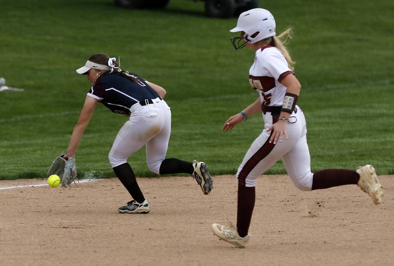 Richmond-Burton's Maddy Hanson fields the ball as Richmond-Burton's Rebecca Lanz runs to third base during a Kishwaukee River Conference softball game on Monday, May 12, 2025, at Richmond-Burton High School in Richmond.