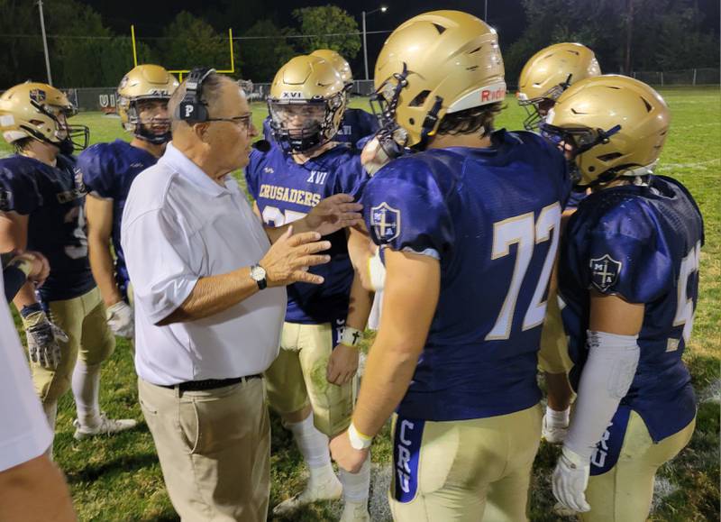 Marquette coach Tom Jobst gives his offense instructions during the fourth quarter on Friday's 26-21 win over Dwight/Gardner-South Wilmington.