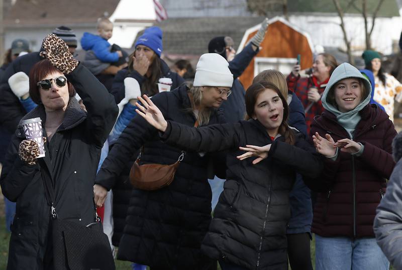 People dance along with the music during a stop in Pingree Grove on Wednesday Nov. 27, 2024, by the Canadian Pacific Kansas City Railway 2024 Holiday Train. The holiday train raised food and monetary donations for the D300 Food Pantry during its stop in Pingree Grove.