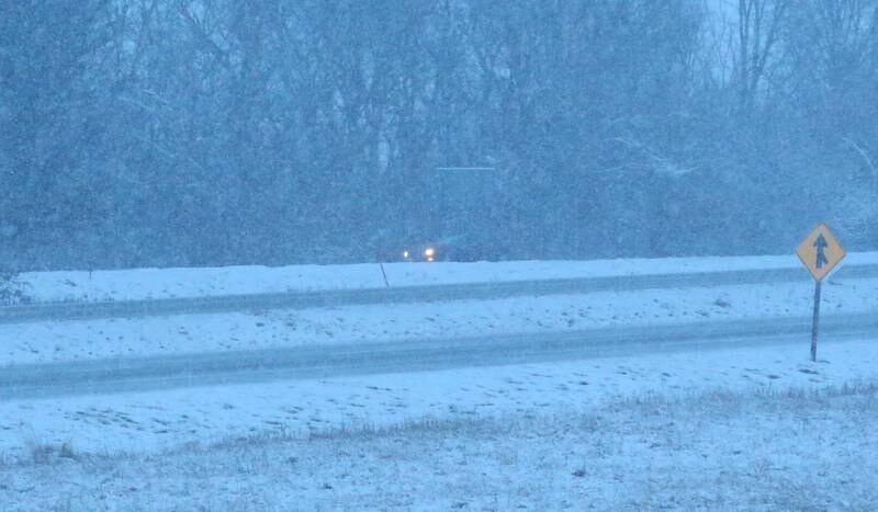 A lone motorist travels Interstate 80 as heavy snow falls at daybreak on Jan. 9, 2024 in Bureau County.