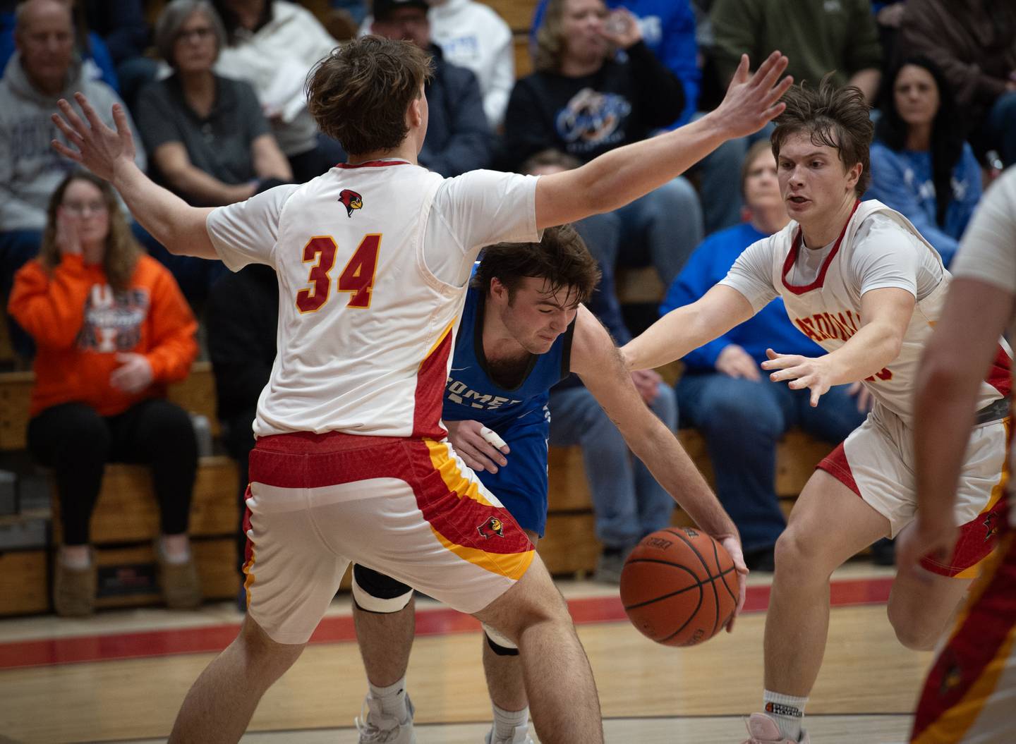 Clifton Central's Blake Chandler, center, is stopped by St. Anne's Jason Bleyle, left, and Grant Pomaranski, right, in the RVC Tournament Championship on Friday, Feb. 13, 2026.