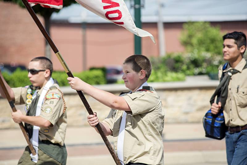 The Boy Scout Troop 85 standard bearer marches with his members through the Dixon Memorial day parade Monday, May 30, 2022.