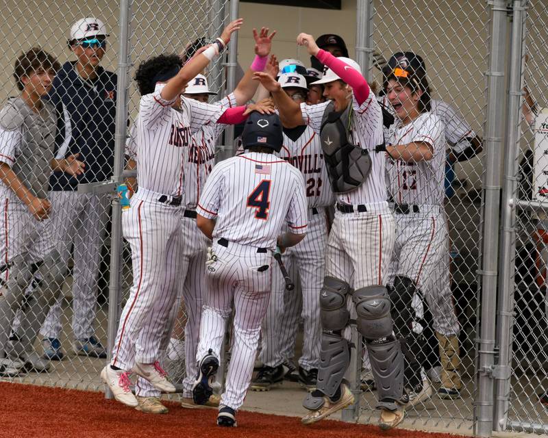 Romeoville's Nolan Holgado (4) gets congratulated by teammates after scoring a run during the regional game against Yorkville on Thursday May 29, 2025, held at Yorkville High School.