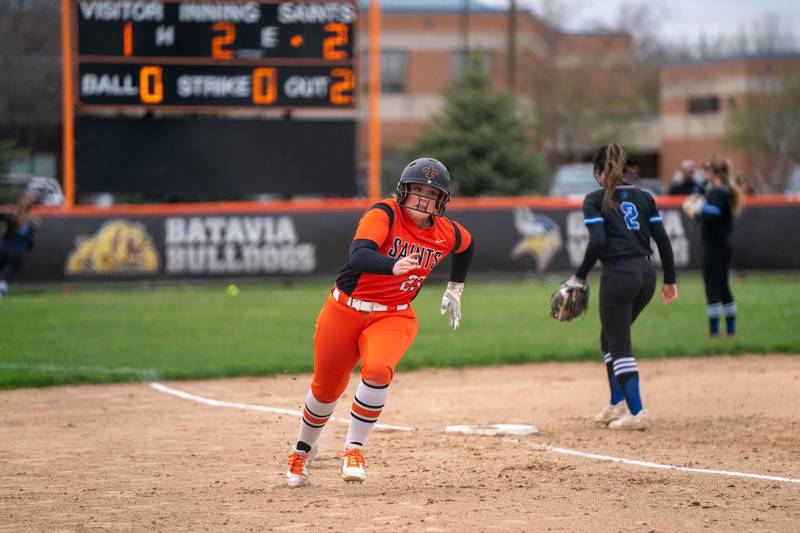 St. Charles East's Katie Morgan (23) rounds third base for a score against St. Charles North during a softball game at St. Charles East High School on Monday, April 25, 2022.