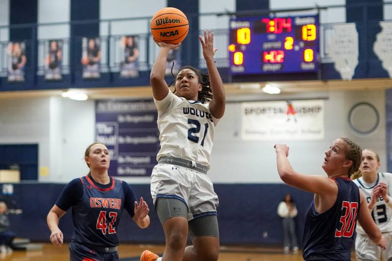 Oswego East's Desiree Merritt (21) shoots a fade away jumper against Oswego during a basketball game at Oswego East High School on Saturday, January 11, 2025.
