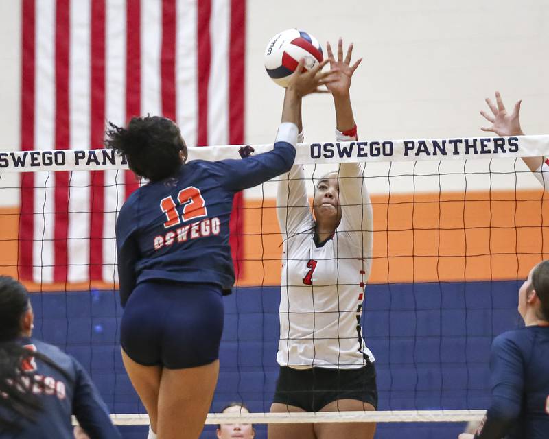 Yorkville's Sophia Blank (7) blocks a tip at the net by Oswego's Laila Lawson (12) during volleyball match between Yorkville at Oswego. Sept 23, 2025.