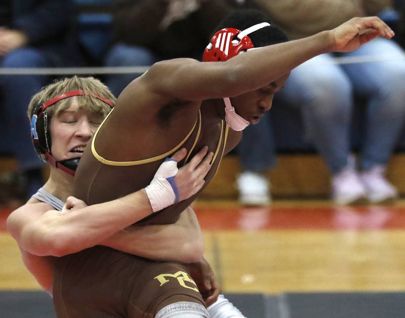 Marian Central's Brayden Teunissen tried to control Mt. Carmel's Kavel Moore in their 120-pound match during a triangle wrestling meet on Saturday Jan. 11, 2025, between Marian Central, Joliet Catholic, and Mt. Carmel at Marian Central High School in Woodstock.