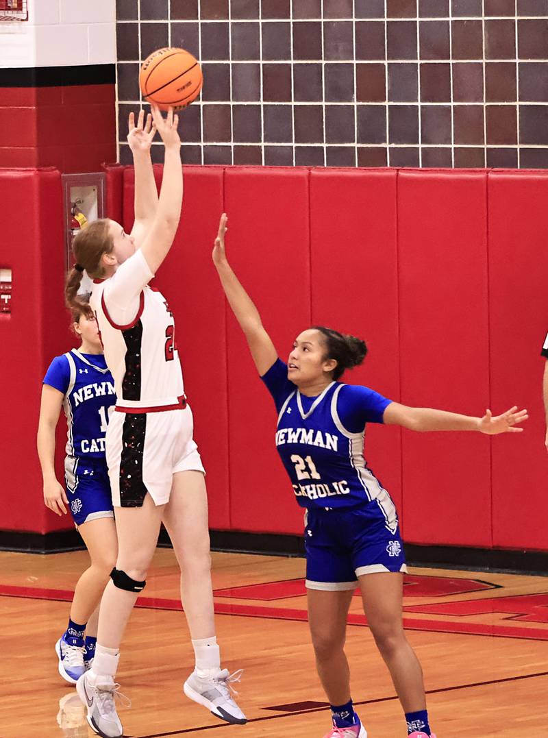 Erie-Prophetstown Eden Jensen jumps above Newman sophomore Gisselle Martin to put 2 in the basket on Thursday, Dec. 11, 2025, in Erie.