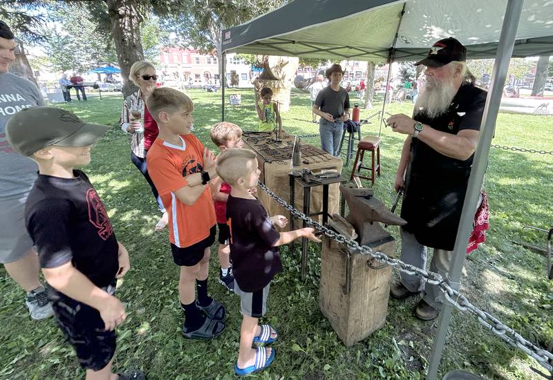 Blacksmith Lloyd Bellows of Oregon talks to visitors at Strawfest on Saturday, Aug. 23, 2025. Visitors could watch Bellows make a variety of iron objects during the Mt. Morris event.