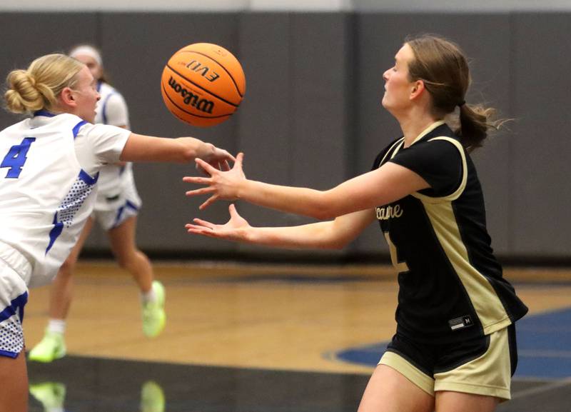 Burlington Central’s  Ashley Waslo, left, and Sycamore’s Sydney Fabrizius reach for the ball in girls basketball at Burlington Central High School in Burlington on Tuesday, November 18, 2025.