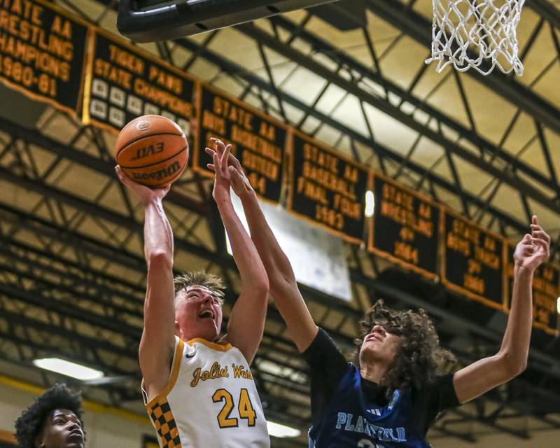 Joliet West's Ryan Lipke (24) draws a foul from Plainfield South's Isaiah Robertson (33) during their basketball game between Plainfield South at Joliet West, Feb 2, 2026 in Joliet.